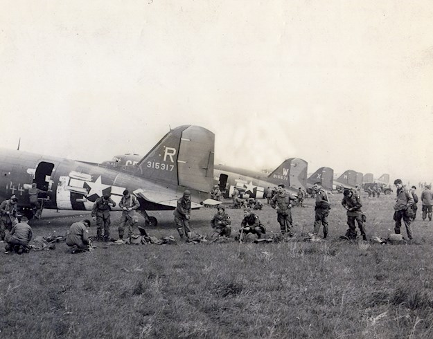 Parachutists of the 82nd Airborne Divsion in front of in front of the airplanes preparing the departure, 1944.