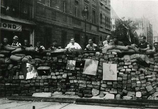Parisians behind a barricade during the insurrection.