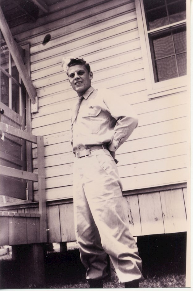 Fred posing in front of a military barrack in the United States. © Glavan family