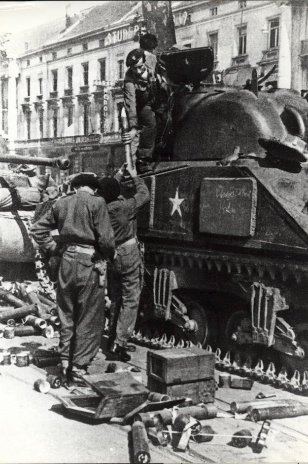 Loading ammunition into a Sherman M4A2 tank.