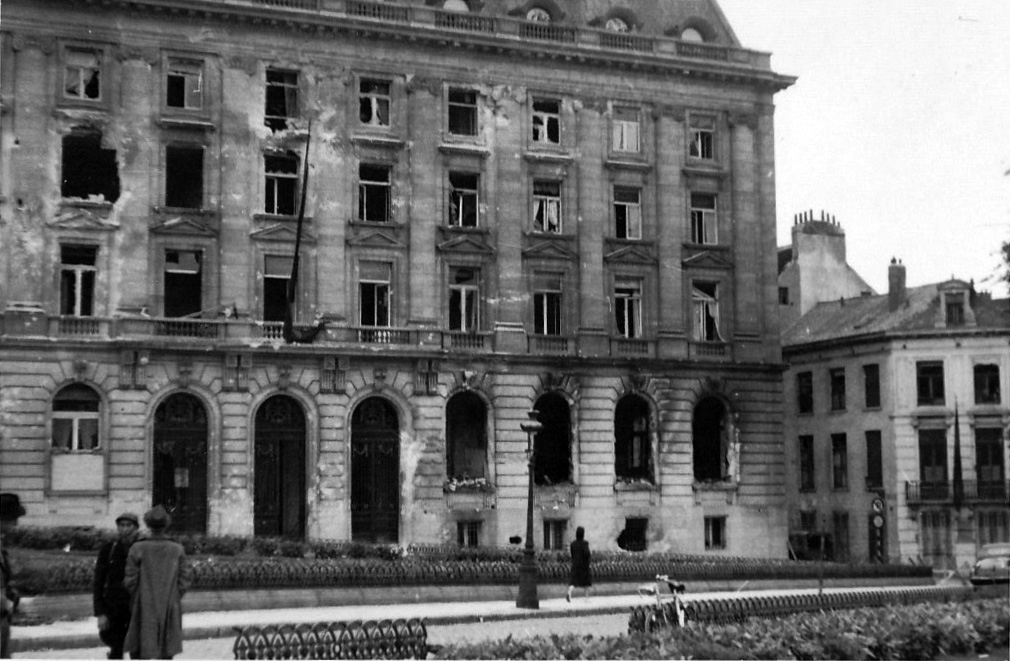 The facade of the Oberfeldkommandantur riddled with bullets, Place du Trône, 4 September 1944